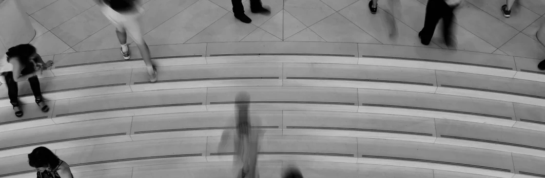 People moving through a modern architectural concourse